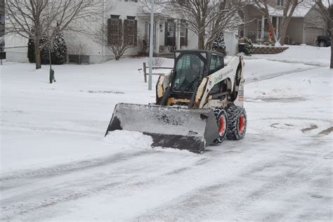 bobcat skid steer plowing snow|best bobcat for snow removal.